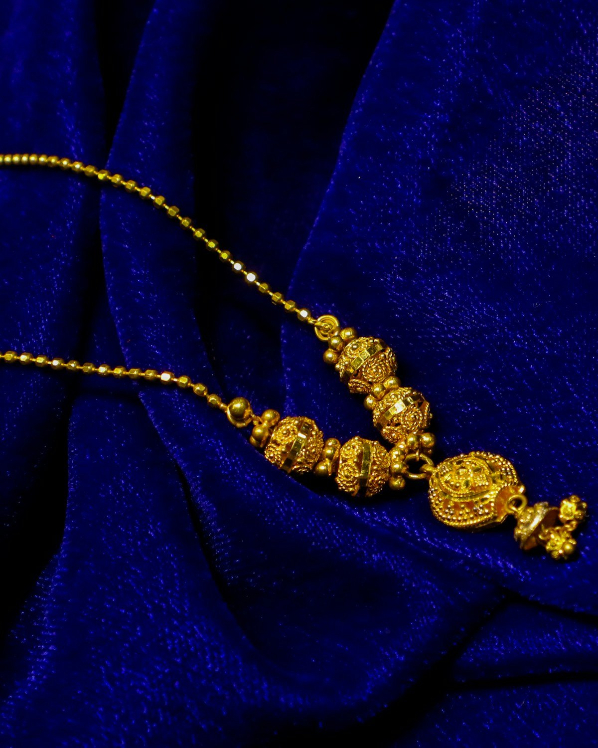 Gold necklace on blue velvet