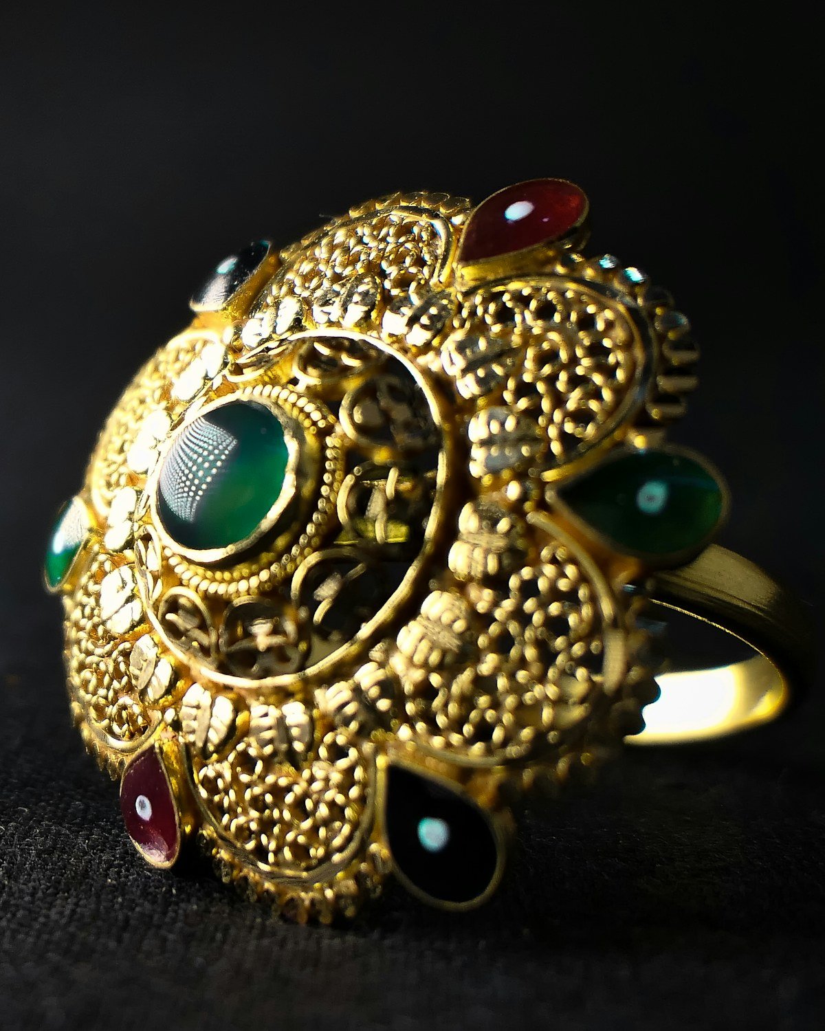 Antique gold ring with green and red stones