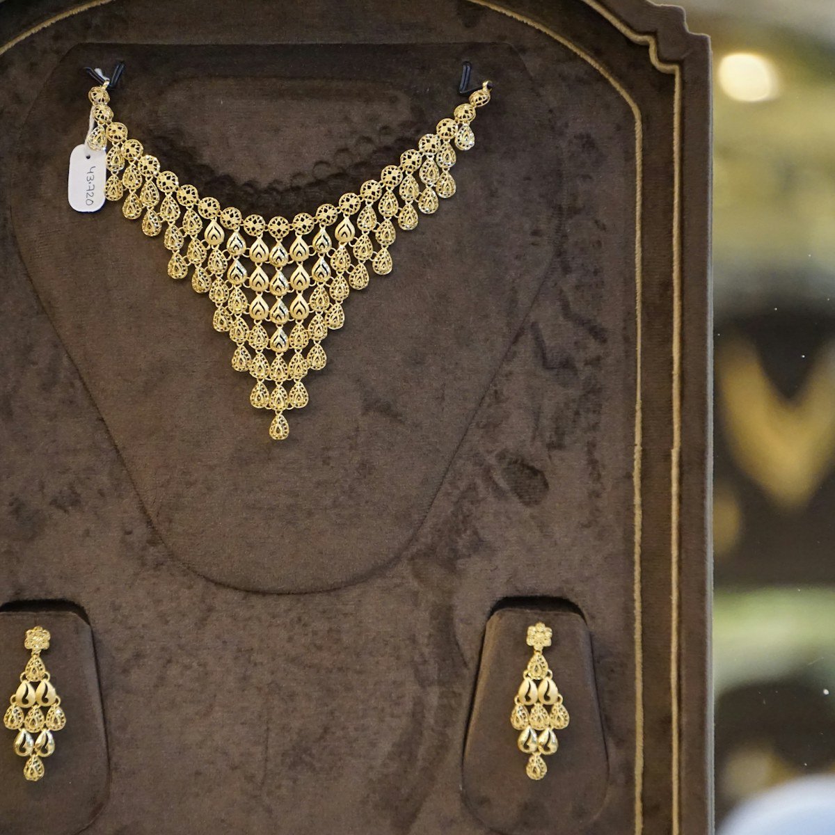 Gold choker and earring set in a display case