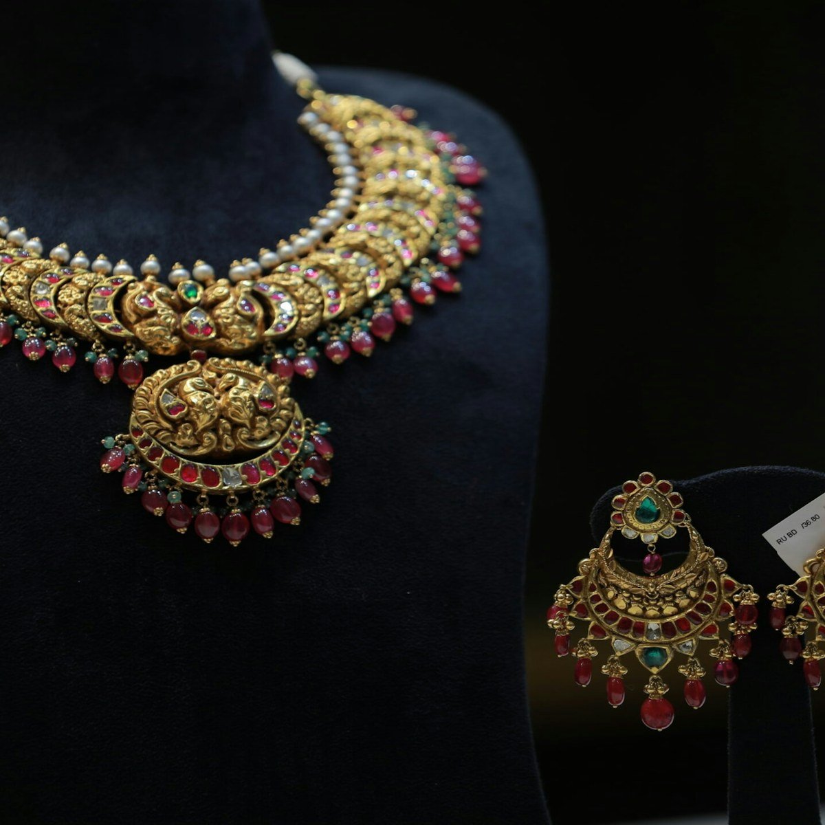 Antique gold necklace set with rubies and emeralds
